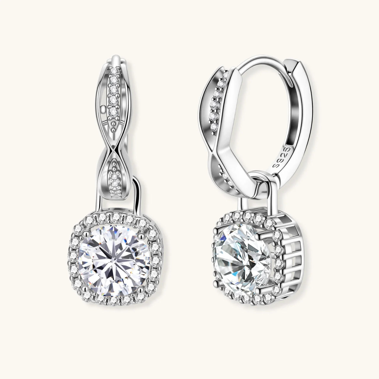 Sterling silver twisted hoop earrings with round moissanite stones in halo settings against neutral background.