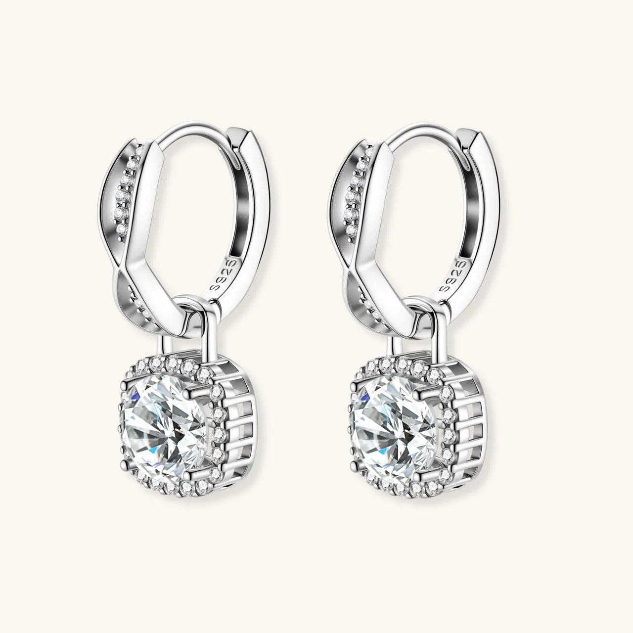 Sterling silver twisted hoop earrings with round moissanite stones in halo settings against neutral background.
