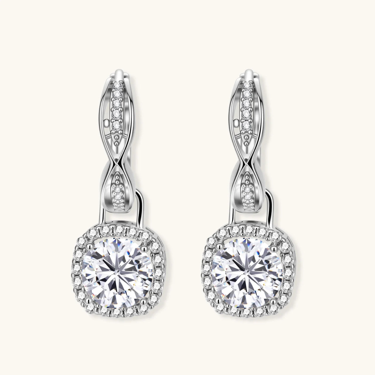 Sterling silver twisted hoop earrings with round moissanite stones in halo settings against neutral background.