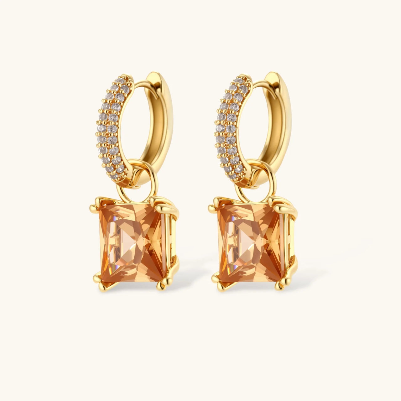 14K gold plated jewelry set featuring square champagne CZ stones with sparkling huggie earrings on cream background.