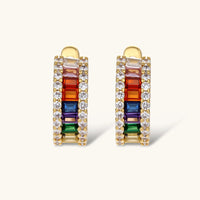 Gold-plated jewelry set featuring rainbow baguette-cut cubic zirconia stones in geometric design on cream background