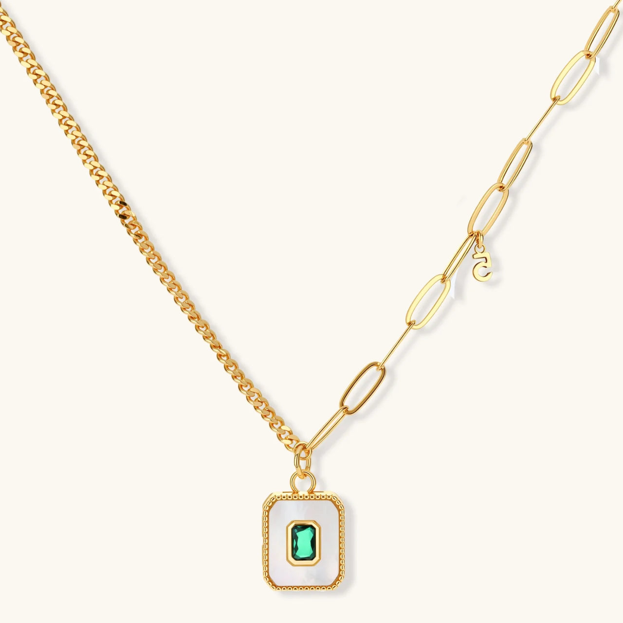 Gold-plated jewelry set with white enamel square pendants and emerald CZ stones on cream background.