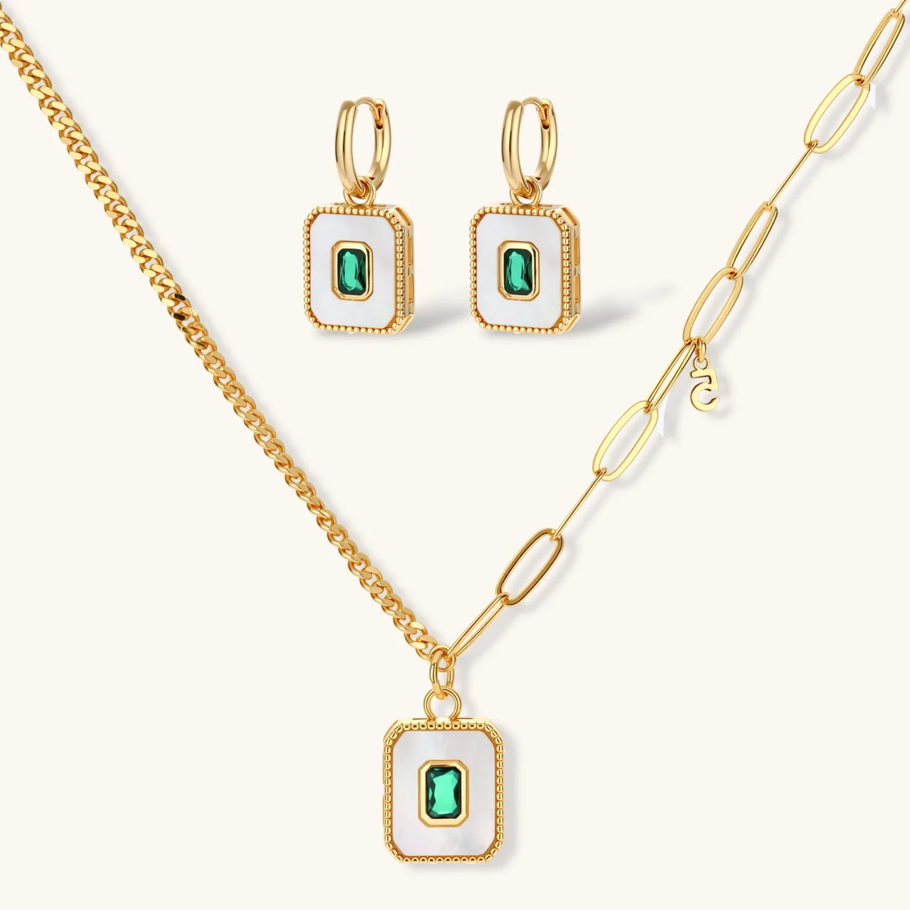 Gold-plated jewelry set with white enamel square pendants and emerald CZ stones on cream background.