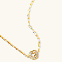 Gold-plated necklace and earring set with circular CZ crystal pendants featuring radial design on cream background