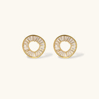 Gold-plated necklace and earring set with circular CZ crystal pendants featuring radial design on cream background
