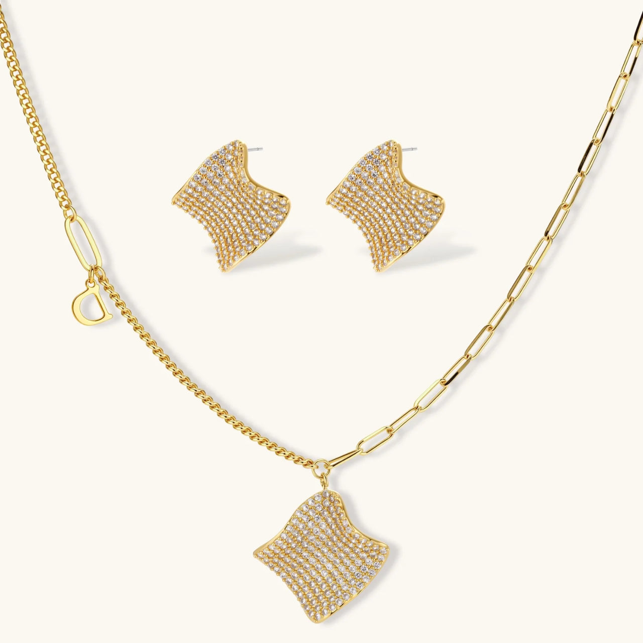 Gold-plated wavy jewelry set with crystal detailing featuring necklace with dual chains and matching textured earrings