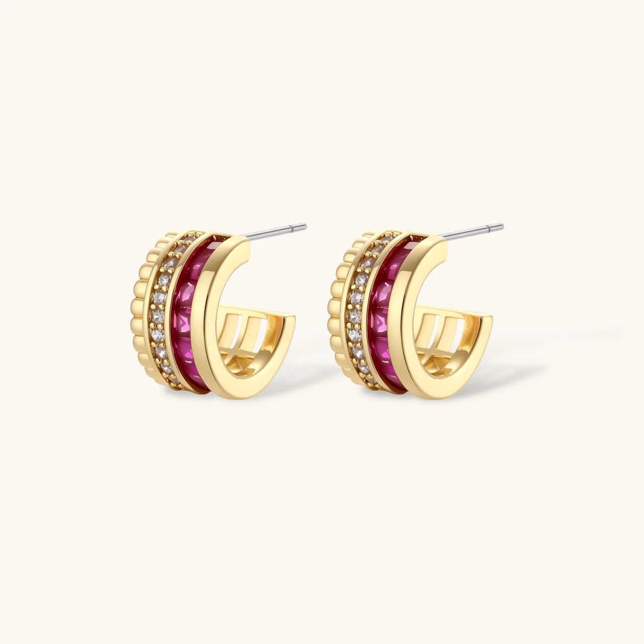 Three-piece jewelry set featuring 14K gold plated pieces with deep red cubic zirconia stones and clear crystals on cream background.