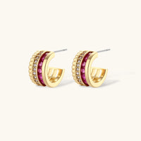 Three-piece jewelry set featuring 14K gold plated pieces with deep red cubic zirconia stones and clear crystals on cream background.