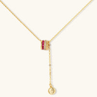 Three-piece jewelry set featuring 14K gold plated pieces with deep red cubic zirconia stones and clear crystals on cream background.