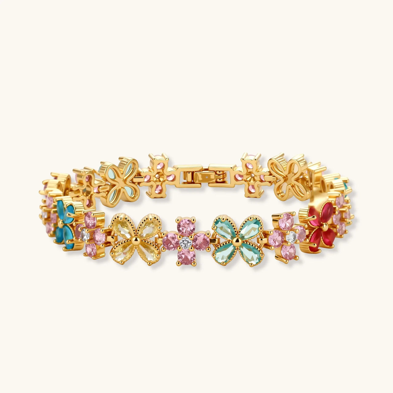 Gold-plated jewelry set with pink, turquoise and red flower-shaped cubic zirconia stones, featuring necklace, earrings and bracelet.