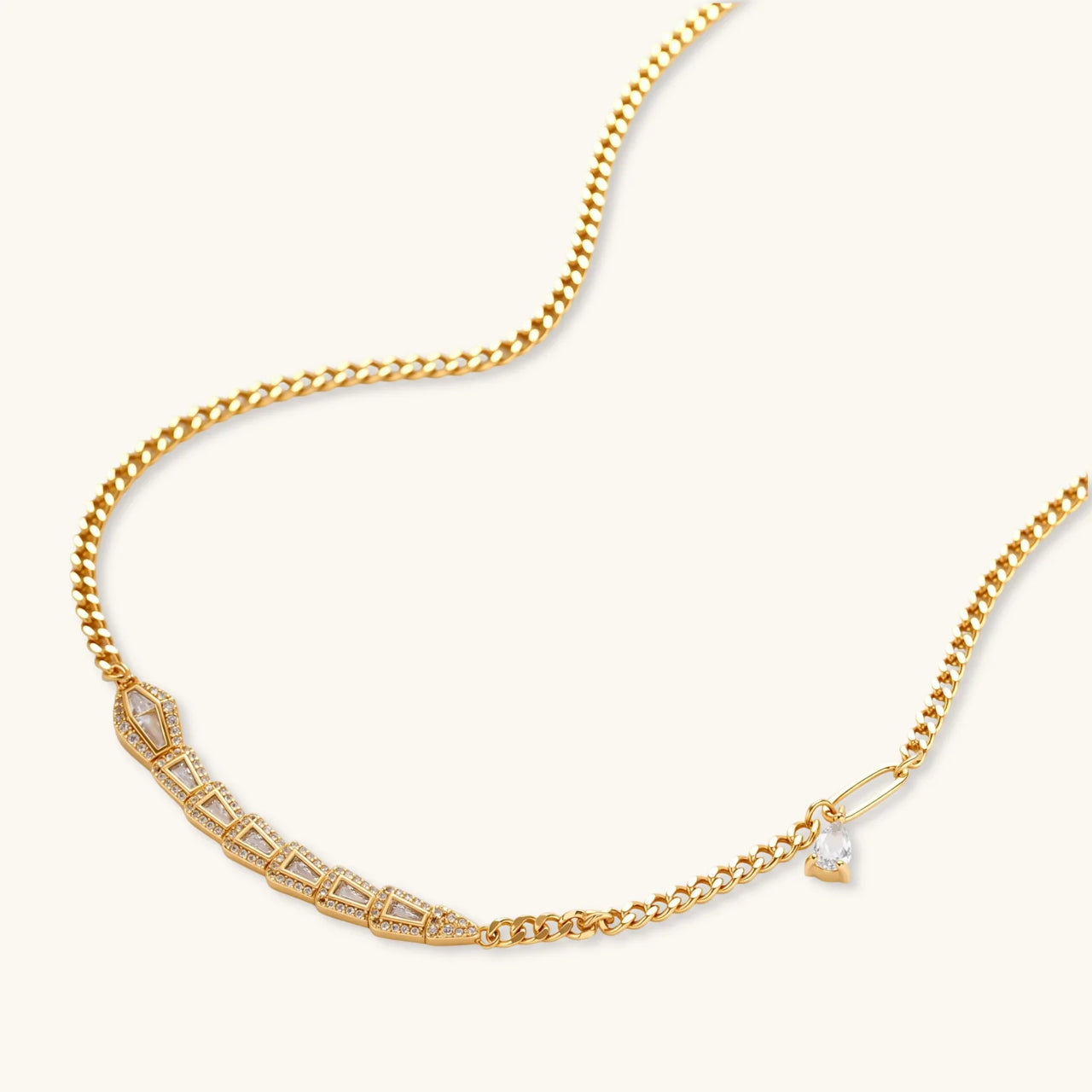 Gold-plated necklace with geometric diamond segments and matching huggie earrings featuring cubic zirconia details
