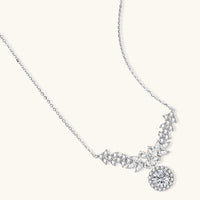 Elegant sterling silver necklace featuring intricate wing-like design with brilliant moissanite stones on neutral background.