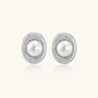 Elegant stud earrings with cream freshwater pearls surrounded by sparkly pavé crystals on rhodium-plated silver setting