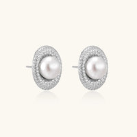Elegant stud earrings with cream freshwater pearls surrounded by sparkly pavé crystals on rhodium-plated silver setting