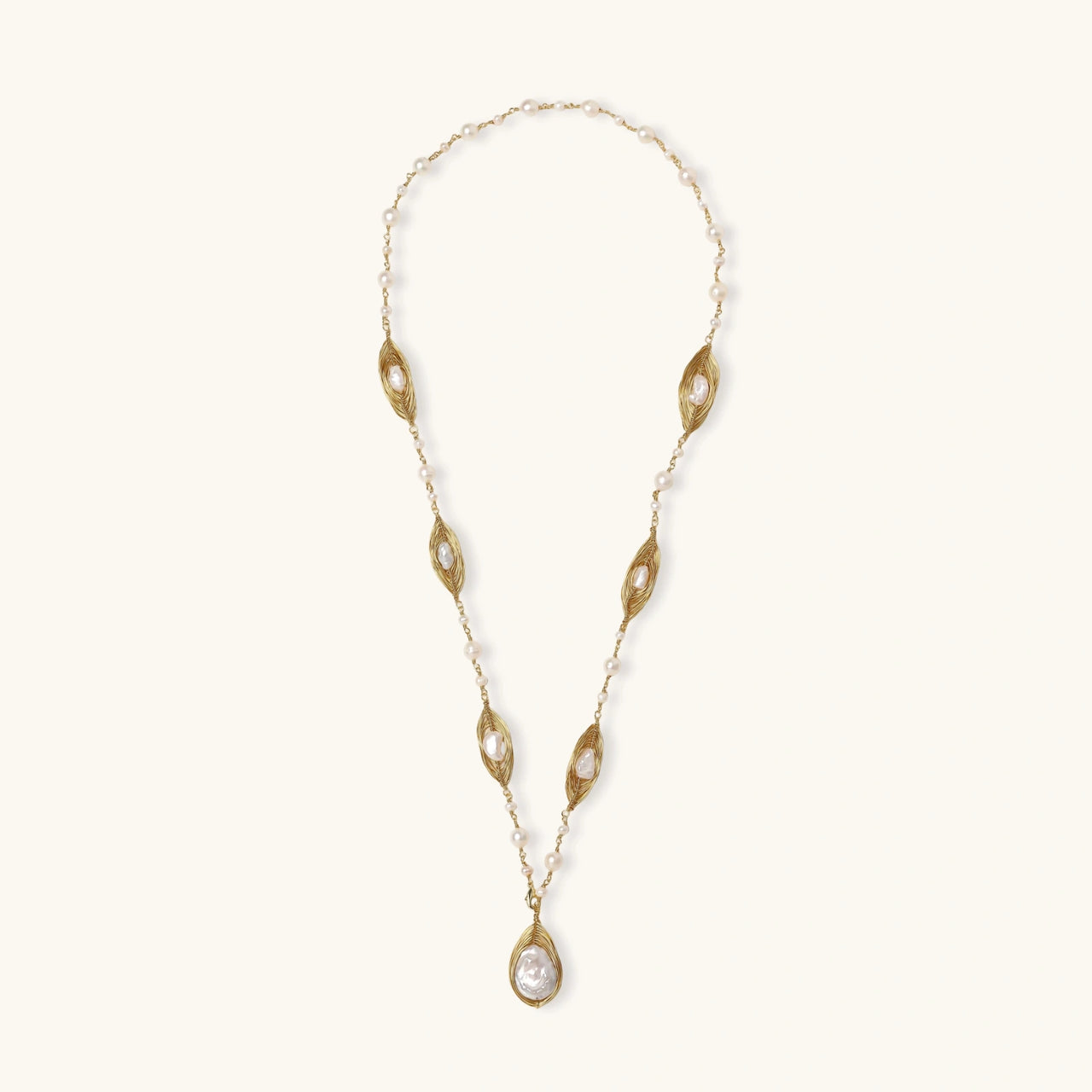 14K gold plated necklace with organic leaf motifs and freshwater pearls arranged in an elegant chain design on neutral background.