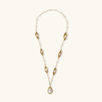 14K gold plated necklace with organic leaf motifs and freshwater pearls arranged in an elegant chain design on neutral background.
