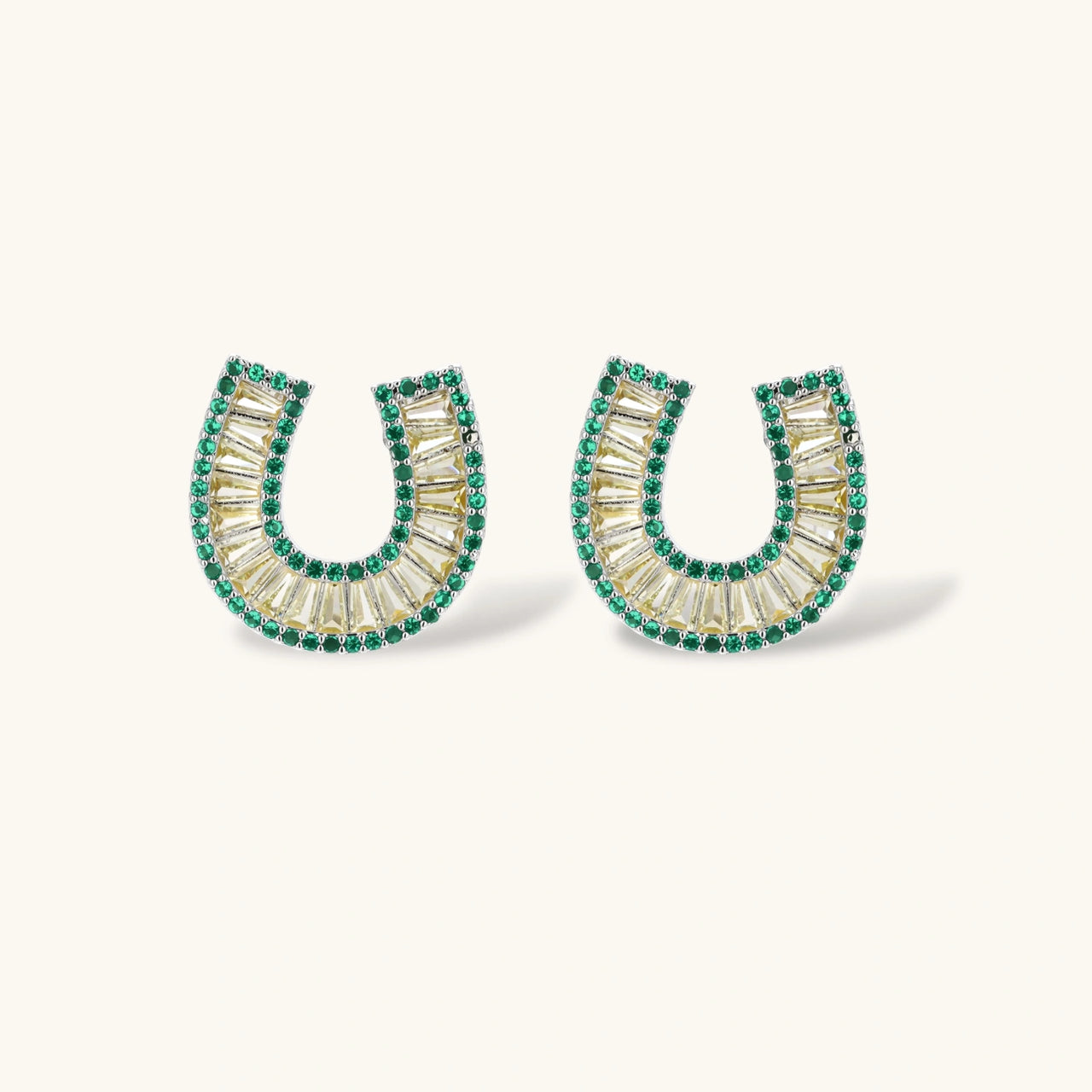 Geometric horseshoe-shaped jewelry set with radiating white zirconia center and jade-green border stones on white background.