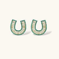 Geometric horseshoe-shaped jewelry set with radiating white zirconia center and jade-green border stones on white background.