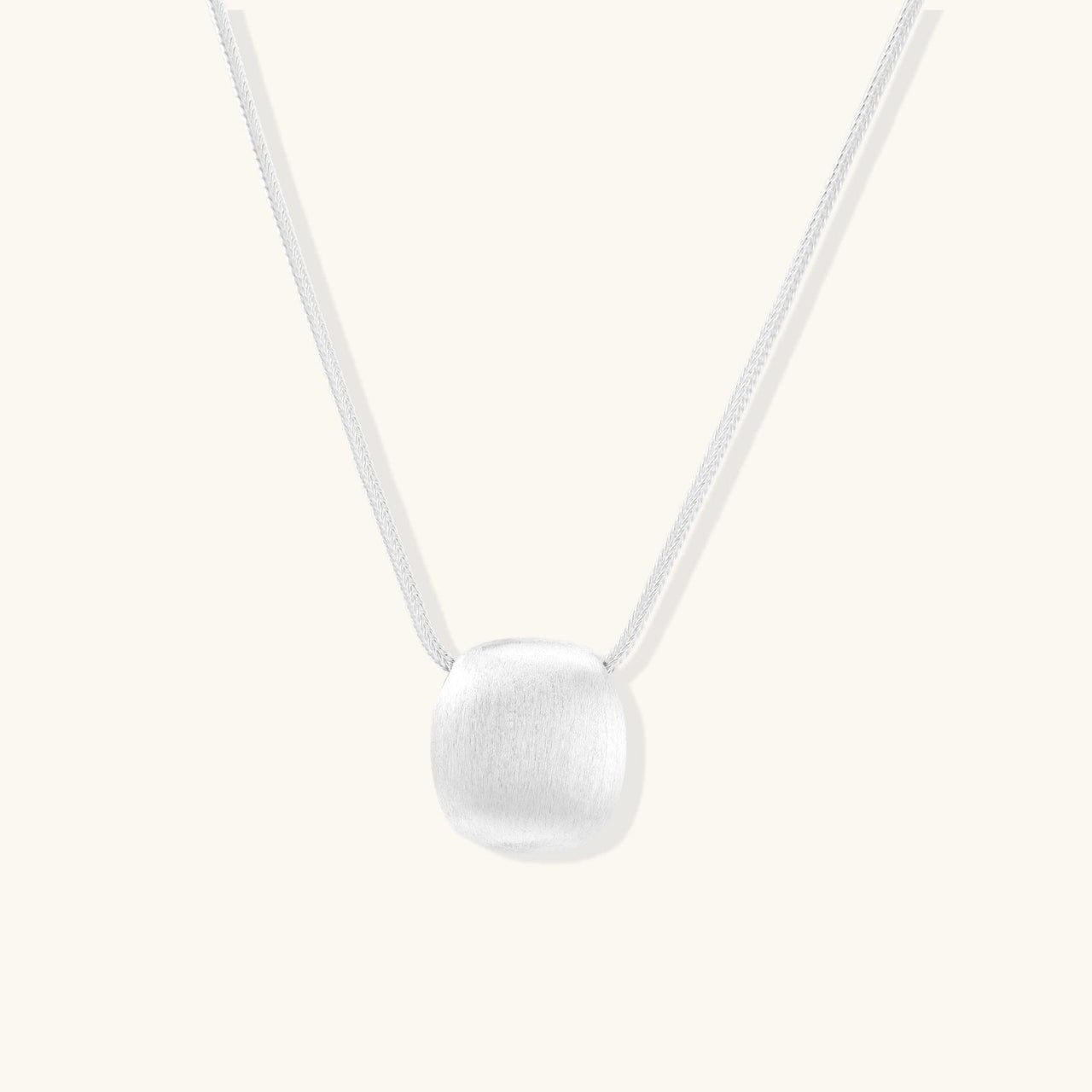 Brushed Silver Disc Necklace showcasing a brushed sterling silver pendant on an adjustable chain.