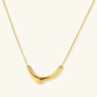 Curve Statement Necklace featuring a sleek gold-plated curved pendant on an adjustable chain.