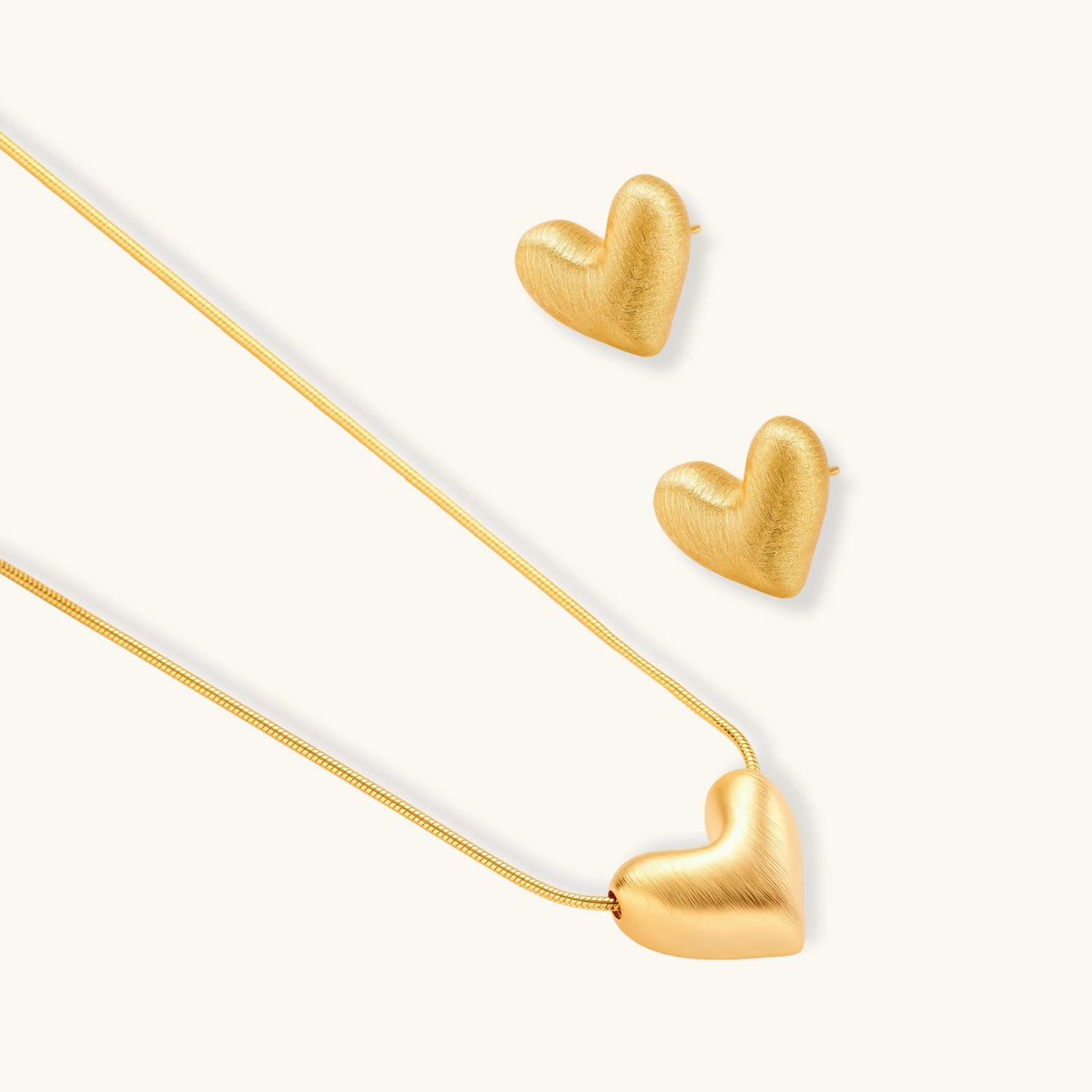 Golden Heart Necklace with matching heart-shaped earrings in 18K gold plating, perfect for layering.