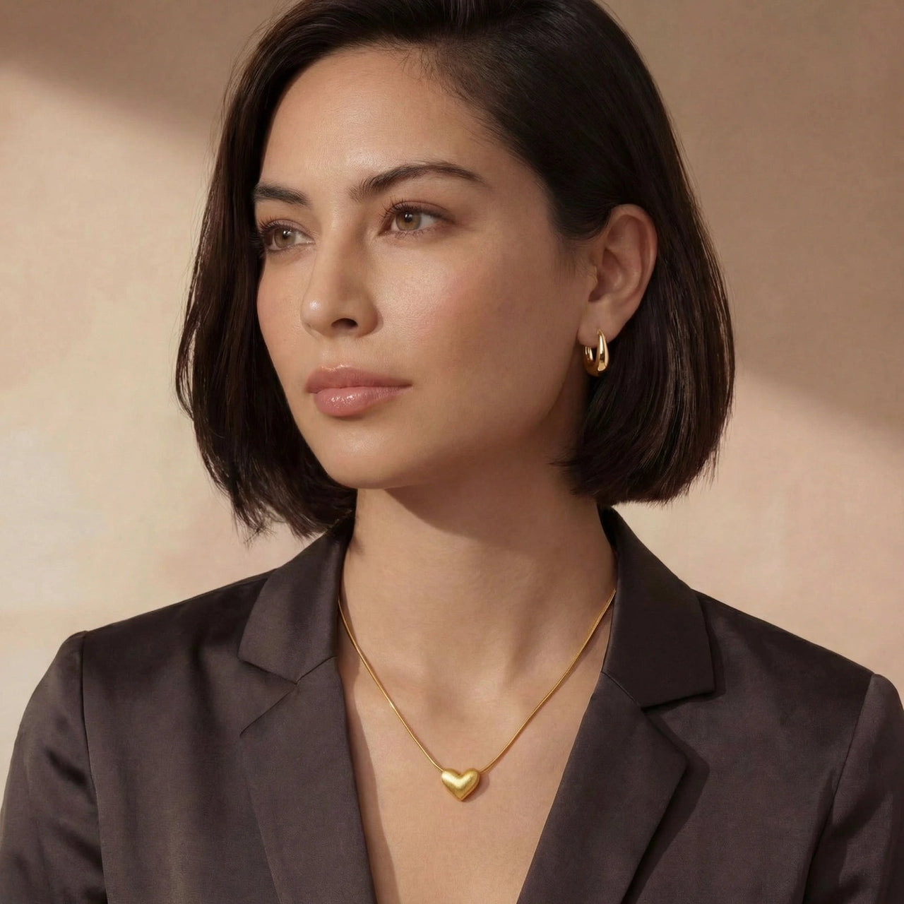 Golden Heart Necklace worn by a model, featuring a dainty heart pendant and adjustable chain.
