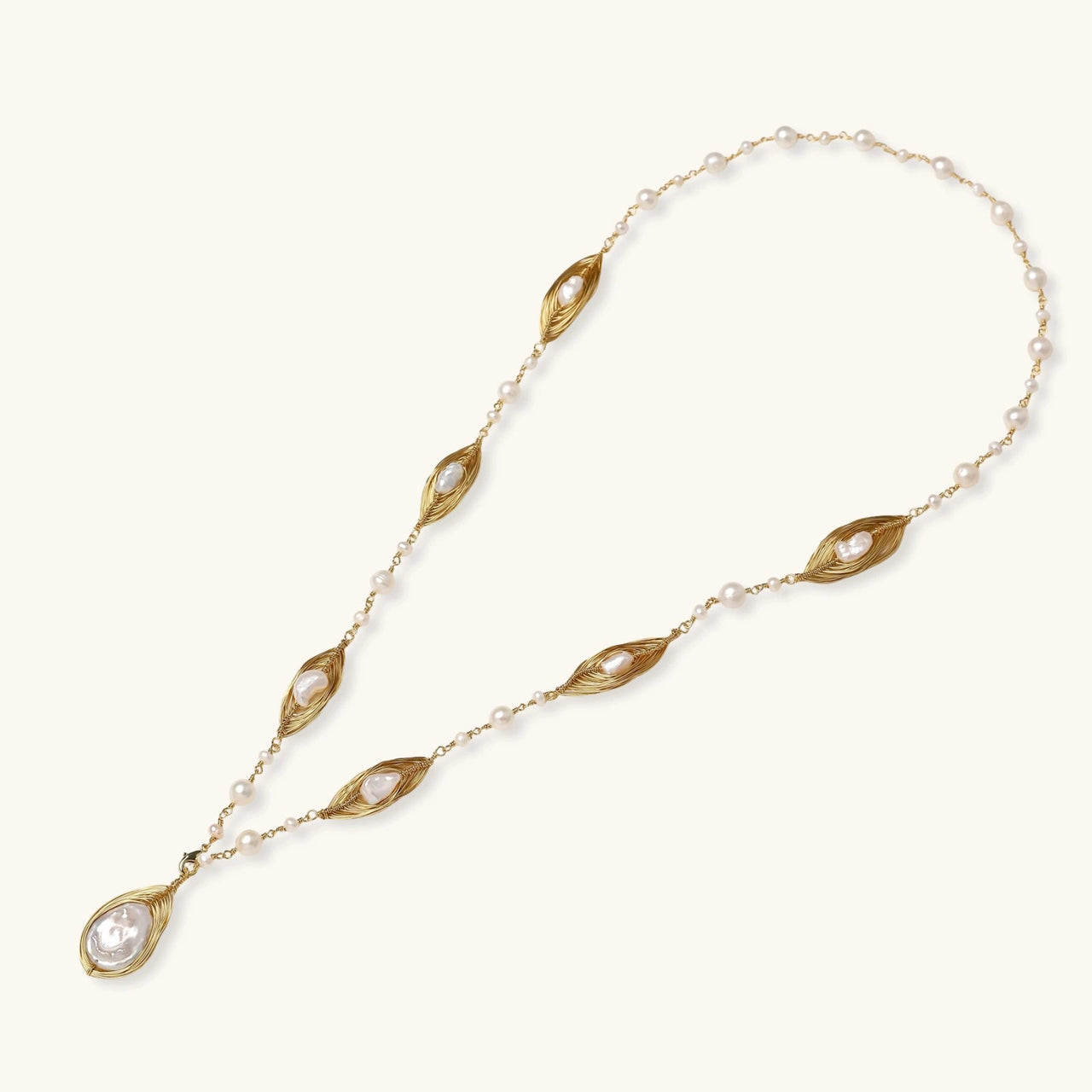 Golden Leaf Baroque Necklace featuring freshwater pearls and sculptural gold-plated leaves.