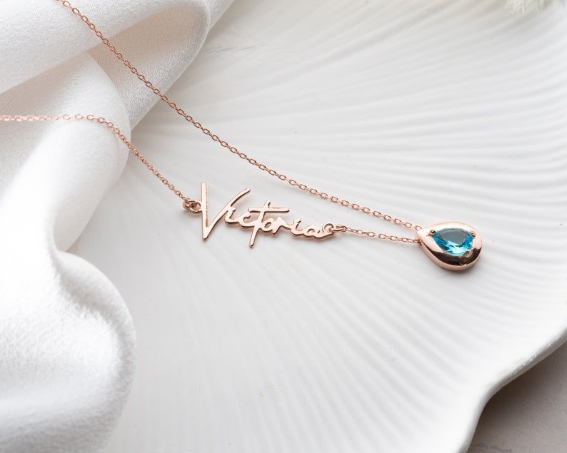 Personalized Cursive Name & Birthstone Necklace featuring a cursive name and birthstone in a minimalist design.