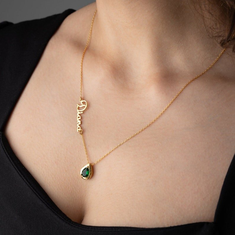 Personalized Cursive Name & Birthstone Necklace featuring a cursive name and green birthstone on a gold chain.
