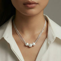 Close-up of a woman wearing a Silver Strand Layers Necklace with brushed sterling silver beads.