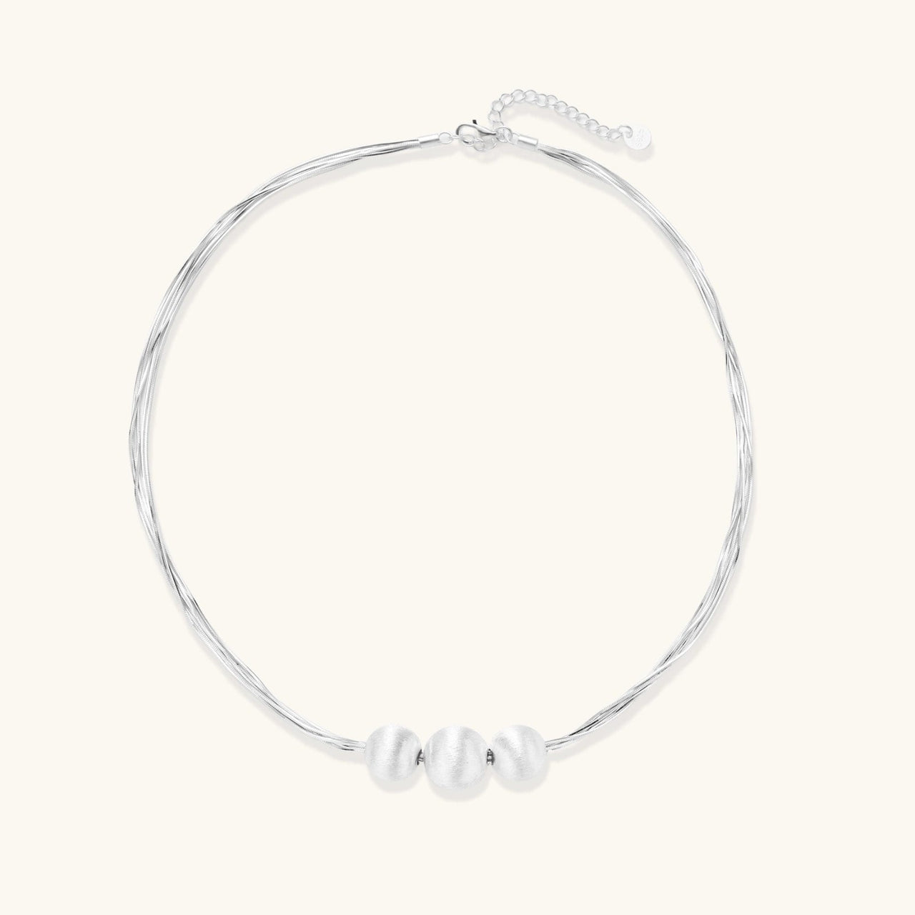 Silver Strand Layers Necklace featuring three brushed sterling silver beads and delicate multi-strand chains.
